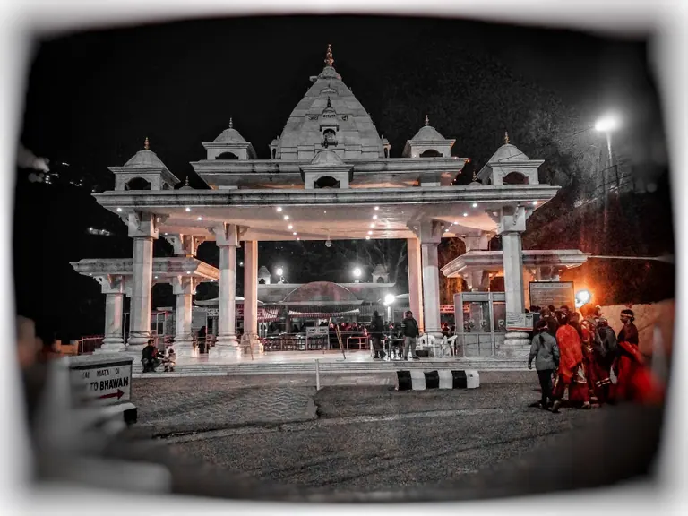 The ornate white gateway at Banganga on the Vaishno Devi yatra route, lit at night