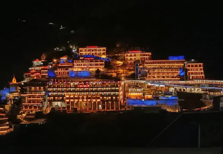 Close view of the Vaishno Devi Bhawan buildings decorated with warm lights at night